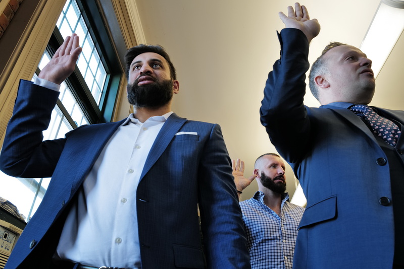 (l to r) Samarth Patel, India, Goce Jankovski, North Macedonia and Jonathan Wcislo, Scotland, are sworn in as U.S. citizens during a naturalization ceremony held at the Immigrants' Assistance Center in New Bedford, MA where twenty-three people from fifteen countries became United States citizens. PHOTO PETER PEREIRA