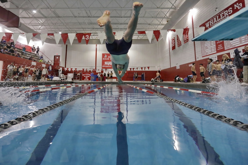 Apponequet's Levi Jope enters the water in his 100-meter winning freestyle race during New Bedford High School against Apponequet High School in New Bedford, MA.  PHOTO PETER PEREIRA