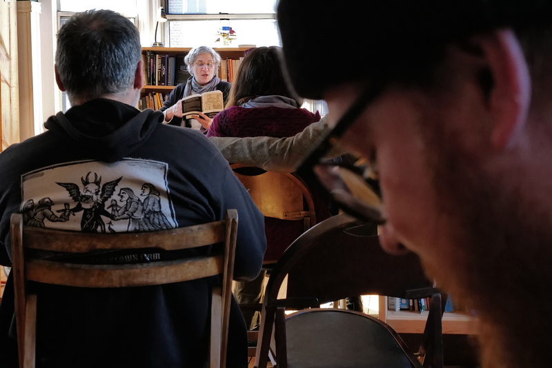 Attendees read along as Nancy Brown reads Bartleby, The Scrivener during the first annual Melville Short Story Marathon at Aviary Books in New Bedford, MA.  PHOTO PETER PEREIRA