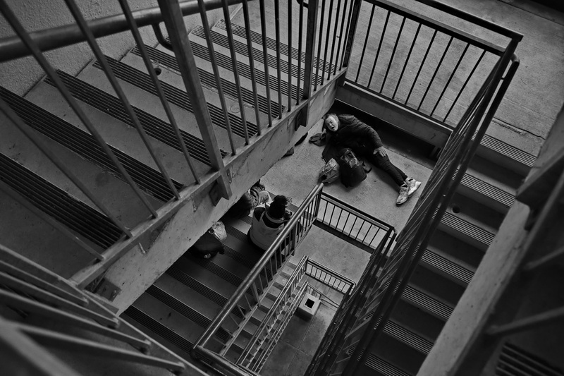 Three homeless people take shelter from the freezing conditions outside to find some heat in the staircase of the Zeiterion Theater parking lot in New Bedford.