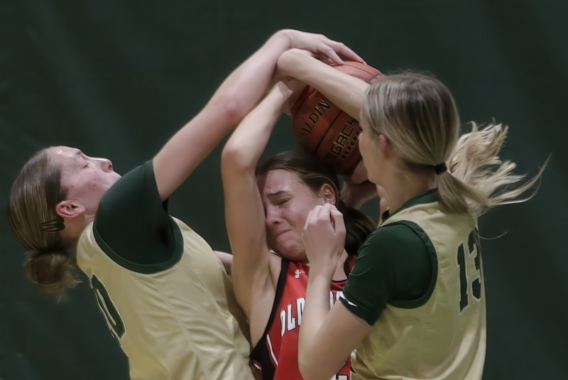 Voc-Tech's Leah Cabral and Lila Emken try to keep ORR's Sadie Hartley-Matteson from shooting the ball during Old Rochester Regional High School's win over Greater New Bedford Regional Vocational Technical High School girls basketball. PHOTO PETER PEREIRA