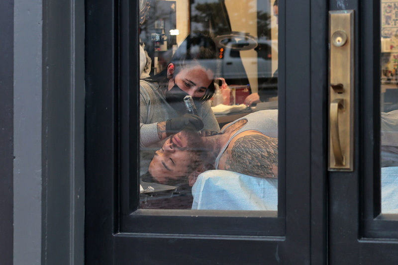 Val Kollars gives a Kevin Nunes a tattoo on his neck at New Bedford Tattoo Company in New Bedford, MA. PHOTO PETER PEREIRA