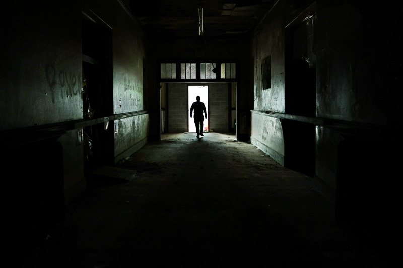 Jon Darling, City of New Bedford public information officer, makes his way out of the front door of the historical Armory building on Sycamore Street in New Bedford, MA. The National Guard Armory was built in 1904 and was a military facility until it was closed in 2004.  It was sold to the City of New Bedford in 2023 for $10, whom is now looking for developers. PHOTO PETER PEREIRA