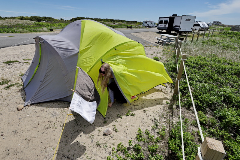 High winds whip the material around as Lucia Mentink emerges from the tent that she and her family visiting from Canada set up at the Horseneck Beach State Reservation campground in Westport, MA. PHOTO PETER PEREIRA