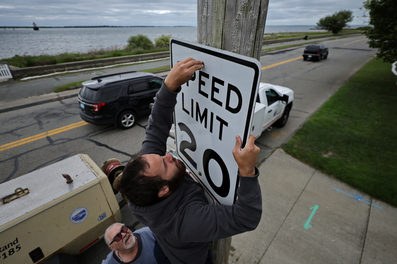 Brian Daviski and Joshua Munoz Gomez from New Bedford DPI put up the twenty miles per hour speed limit sign on East Rodney French Boulevard in New Bedford, MA as part of the preparations for the beach season. Typically, the speed limit in this area is thirty miles per hour.  PHOTO PETER PEREIRA