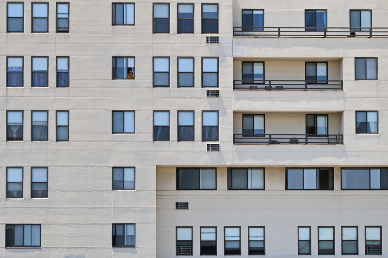 A man enjoys the view from an apartment complex in downtown New Bedford, MA. PHOTO PETER PEREIRA