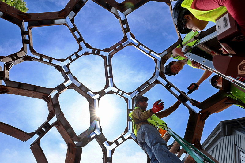 A fabrication team install the Mood-Vironment sculpture by Mona Ghandi at the intersection of Union Street and Route 18 in downtown New Bedford, MA.  The interactive installation provides a dynamic immersive atmosphere and is produced by Massachusetts Design Art & Technoloy, DATMA. PHOTO PETER PEREIRA