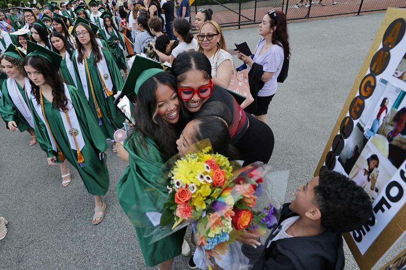 Families hug upon seeing their graduate for the first time after the completion of the 2025 Greater New Bedford Regional Vocational Technical High School graduation ceremony in New Bedford, MA. PHOTO PETER PEREIRA