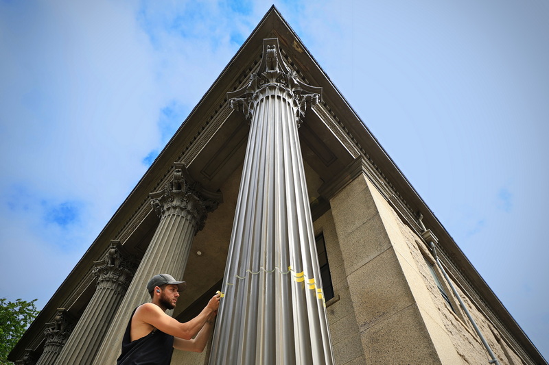 Justin Blanchard of Forma Beyond Imagination puts the final touches on the expansion joint of the Corinthian column he fabricated for the colonnade of the William Rodman House & Annex building on County Street in New Bedford, MA which is currently for sale. PHOTO PETER PEREIRA