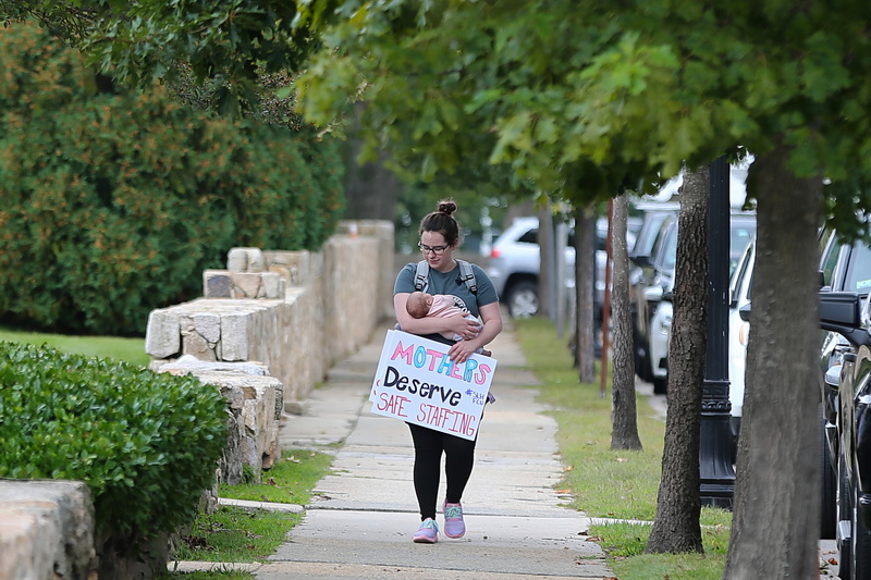 St. Lukes Hospital labor and delivery nurse, Renee LaFae carries her seven week old daughter Ophelia LaFae to a demonstration in front of St. Luke Hospital in New Bedford, MA. PHOTO PETER PEREIRA