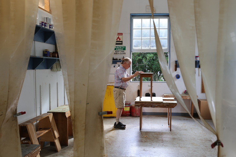 Gary Adriance, owner, sands down a table he is making, in the sanding area of Adriance Furnituremakers on Gulf Road in Dartmouth, MA.  PHOTO PETER PEREIRA