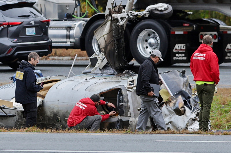 NTSB officials document the state of the fuselage of the fatal plane crash on I-195 in Dartmouth, MA. PHOTO PETER PEREIRA