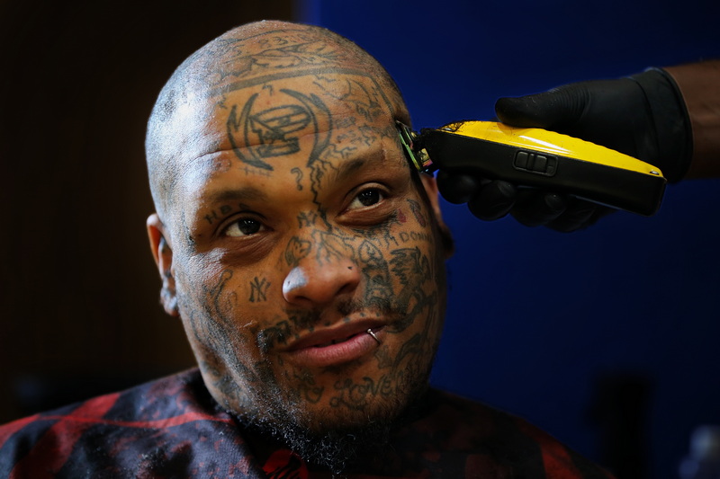 Anthony Russell sits for a free haircut by Nick Joaquim of The Spot Barber Lounge at the annual New Bedford Connect conference held at the New Bedford YMCA with various resources and services for individuals and families who are unhoused or are at risk. PHOTO PETER PEREIRA