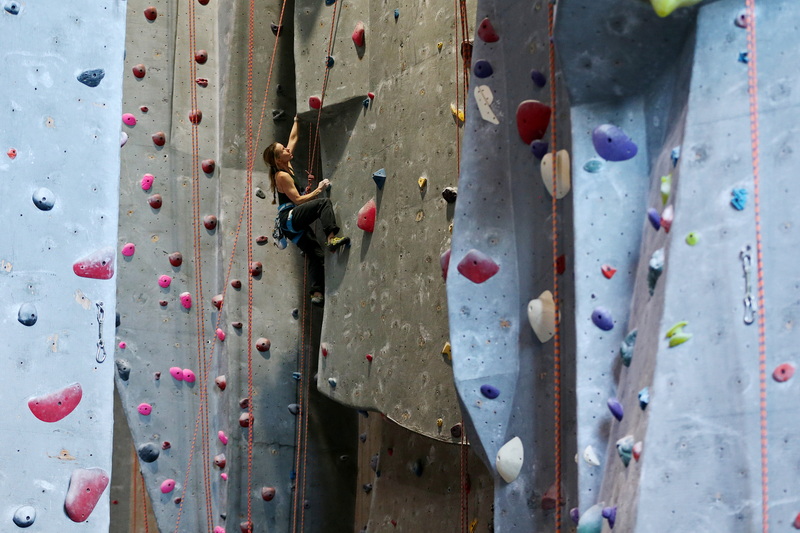 Nicole Jackson pauses to plot her ascent on a sixty foot wall inside of the Carabiner's Climbing and Fitness indoor climbing gym in New Bedford, MA. PHOTO PETER PEREIRA
