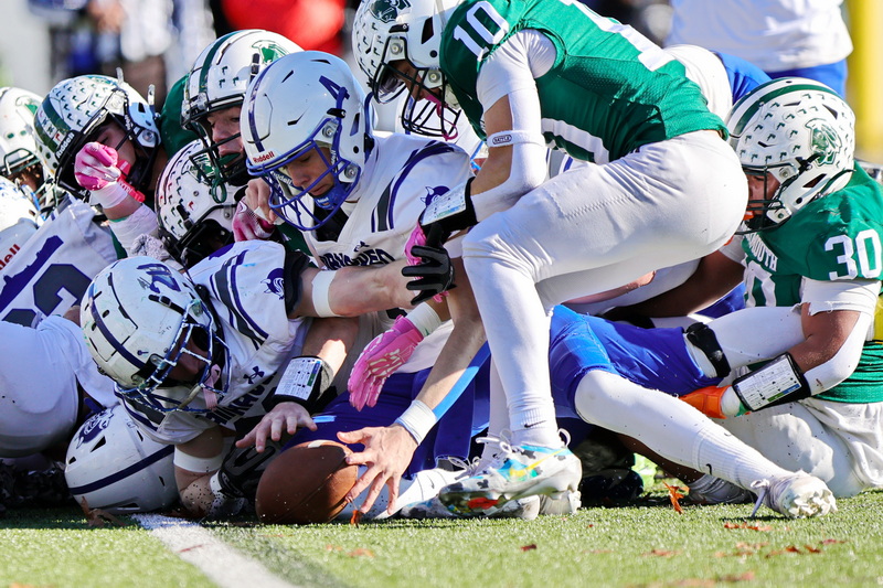 Fairhaven High School quarterback Evan Lamontagne tries to grab the ball that was dropped by running back Grant Darmofal at the goaline during their win against Dartmouth High School on Thanksgiving Day football. PHOTO PETER PEREIRA
