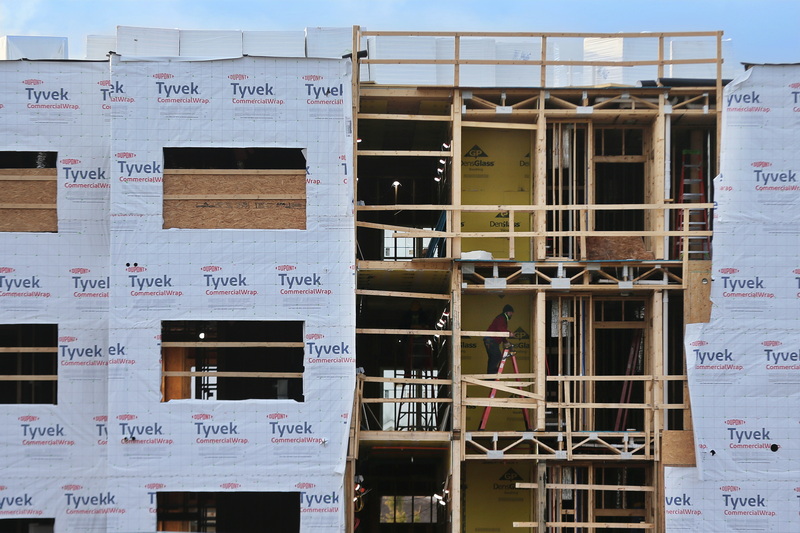A worker is seen inside the exposed section of the condominium complex being constructed on Dartmouth Street in Dartmouth, MA. PHOTO PETER PEREIRA