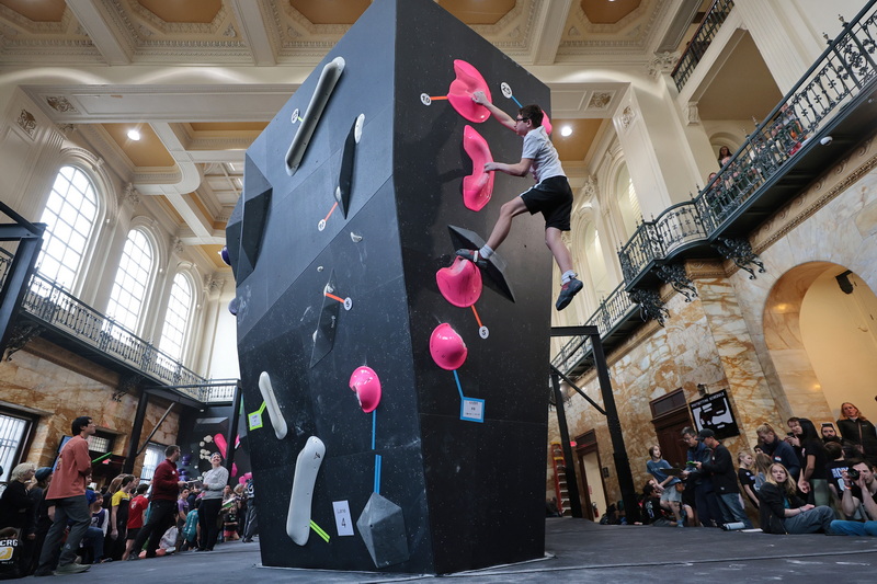 Billy Britt, 13, who drove down from Maine, makes it to the top of the wall during the USA Climbing regional championship qualifying event held at Bolder Union on Union Street in New Bedford, MA. PHOTO PETER PEREIRA