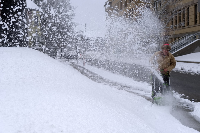 Glenn Souza uses a snowblower to clear the sidewalk around the Superior Courthouse in New Bedford, MA. PHOTO PETER PEREIRA