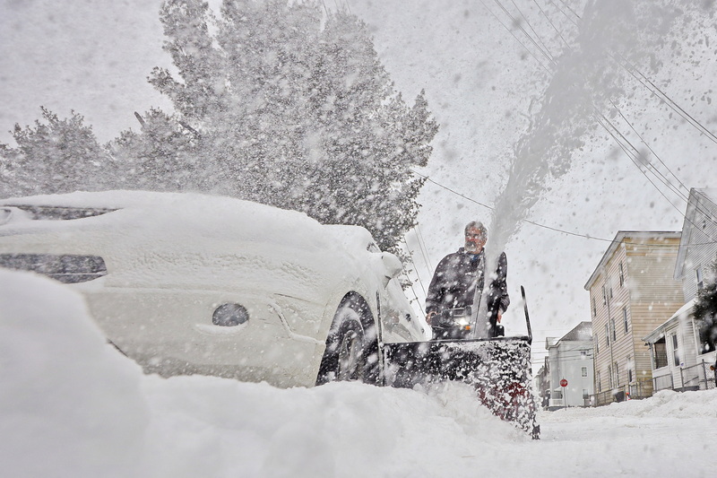 Arthur Roderick sends snow flying into the air using his snowblower as he digs out his vehicle from the snowstorm which covered the Southcoast in over twelve inches of snow. PHOTO PETER PEREIRA