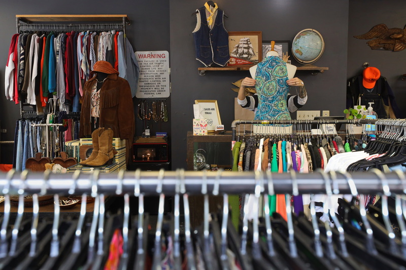 Kay Lynne, owner, dresses a mannequin in vintage clothing at The MadLila on Purchase Street in New Bedford, MA. PHOTO PETER PEREIRA