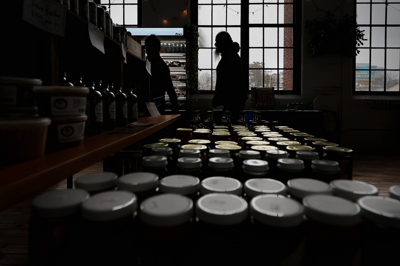 A man shops for food items produced by local farmers at the Coastal Floodshed's new space at the Kilburn Mill in New Bedford, MA.  PHOTO PETER PEREIRA