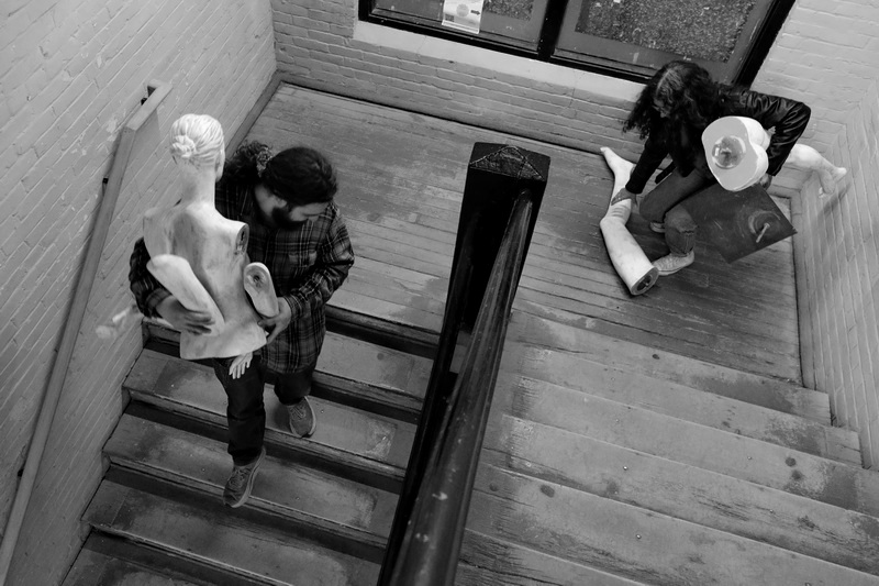 Claudia DeSousa-Baptista gathers the parts while she and Andrew Casteel carry a mannequin he gifted her down the stairs of Kilburn Mill to take it back to her studio in downtown New Bedford, MA.  PHOTO PETER PEREIRA