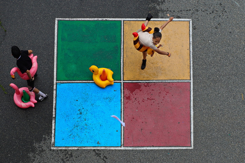 Fifth grader Nathano Martinez casts a wet sock at a target from a colorful square painted on the ground, as he and fellow Congdon Elementary School students enjoy a field day on their last days of school in New Bedford, MA.  The Congdon Elementary School which was built in 1907, will be moving into its new location at the Congdon-DeValles Elementary School next year. PHOTO PETER PEREIRA