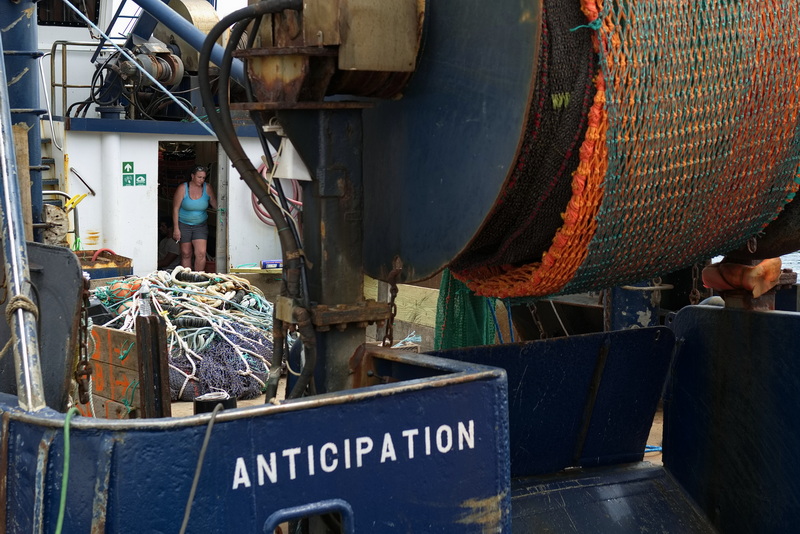 On July 28, 2026, Captain Amy McDonald pauses briefly after fitting a new squid net, transforming the fishing vessel Anticipation from scallop fishing to squid catching as she prepares to return to sea from New Bedford. PHOTO PETER PEREIRA