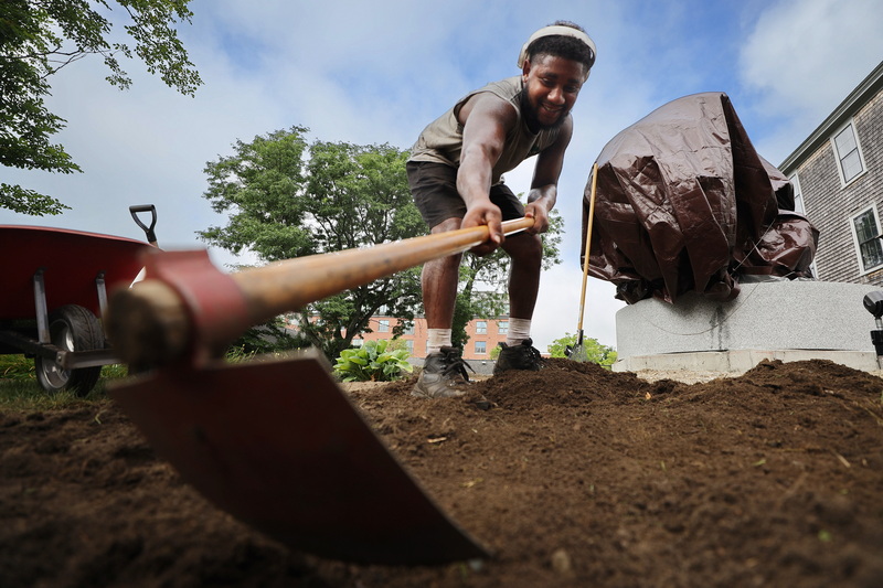 On August 6, 2026 Jomari Woodlen uses a hoe to prepare the landscaping for the unveiling of the Herman Melville statue in front of the Seamen's Bethel in New Bedford, MA later this month. PHOTO PETER PEREIRA