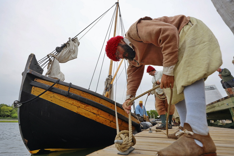 Sam Allen ties off The Shallop boat during the Blockade Runners stop in Padanaram Harbor in Dartmouth, MA on August 17, 2026  commemorating Capt. Paul Cuffe, who navigated a shallop boat between the mainland and Nantucket during the Revolutionary War to bring supplies and food to island inhabitants isolated by the British blockade. PHOTO PETER PEREIRA