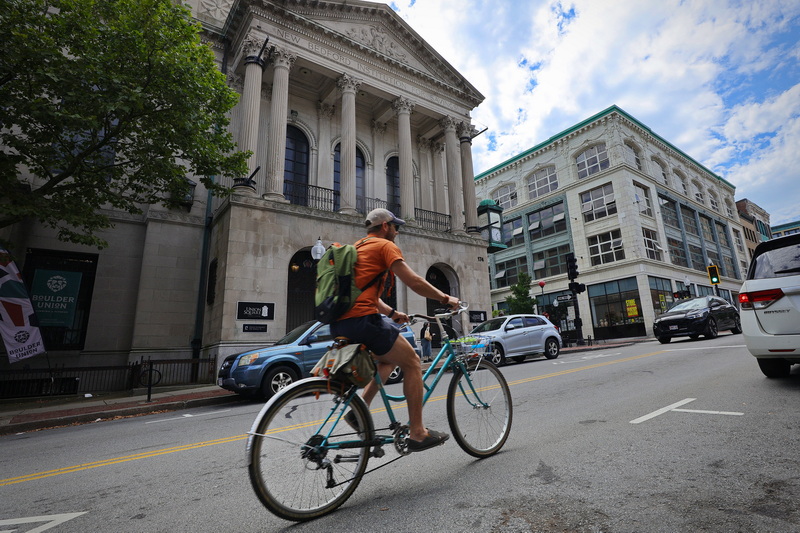 Will Gardner rides his classic bicycle up Union Street in New Bedford, MA on August 20, 2026. Int he background the former New Bedford Institution for Savings and the Star Store. PHOTO PETER PEREIRA