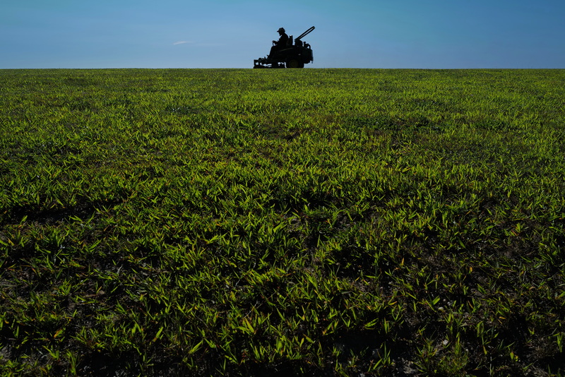A New Bedford DPI employee is positioned against the clear blue sky while mowing the neatly trimmed grass at Fort Taber Park in New Bedford, MA using a lawn tractor on August 26, 2026. PHOTO PETER PEREIRA