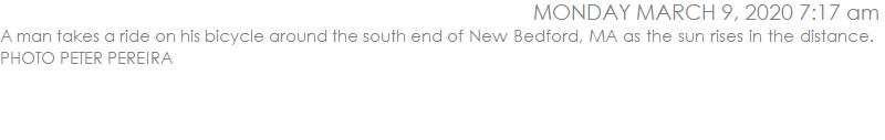 A man takes a ride on his bicycle around the south end of New Bedford, MA as the sun rises in the distance.   PHOTO PETER PEREIRA
