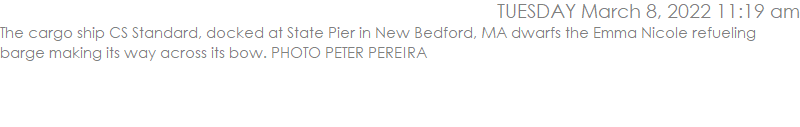 The cargo ship CS Standard, docked at State Pier in New Bedford, dwarfs the refueling barge making its way across its bow. PHOTO PETER PEREIRA