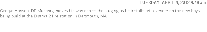 George Hanson, DP Masonry, makes his way across the staging as he installs brick veneer on the new bays being build at the District 2 fire station in Dartmouth, MA.