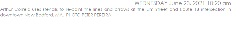 Arthur Correia uses stencils to re-paint the lines and arrows at the Elm Street and Route 18 intersection in downtown New Bedford, MA.  PHOTO PETER PEREIRA