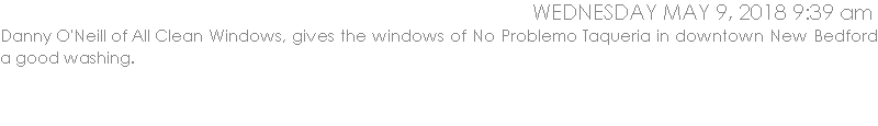 Danny O'Neill of All Clean Windows, gives the windows of No Problemo Taqueria in downtown New Bedford a good washing.  