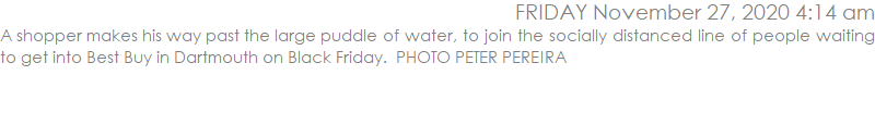 A shopper makes his way past the large puddle of water, to join the socially distanced line of people waiting to get into Best Buy in Dartmouth on Black Friday.  PHOTO PETER PEREIRA
