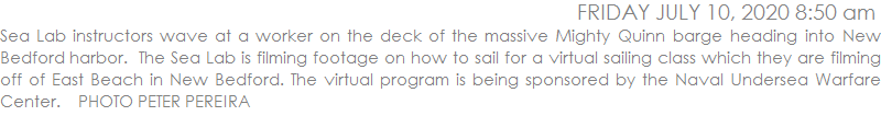 Sea Lab instructors wave at a worker on the deck of the massive Mighty Quinn barge heading into New Bedford harbor.  The Sea Lab is filming footage on how to sail for a virtual sailing class which they are filming off of East Beach in New Bedford. The virtual program is being sponsored by the Naval Undersea Warfare Center.    PHOTO PETER PEREIRA