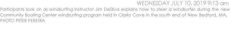 Participants look on as windsurfing instructor Jim DeSilva explains how to steer a windsurfer during the new Community Boating Center windsurfing program held in Clarks Cove in the south end of New Bedford, MA.   PHOTO PETER PEREIRA