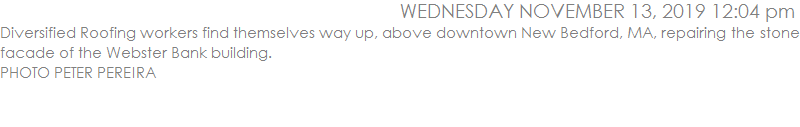 Diversified Roofing workers find themselves way up, above downtown New Bedford, MA, repairing the stone facade of the Webster Bank building. 