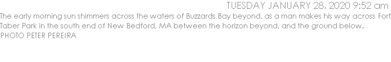 The early morning sun shimmers across the waters of Buzzards Bay beyond, as a man makes his way across Fort Taber Park in the south end of New Bedford, MA between the horizon beyond, and the ground below. 