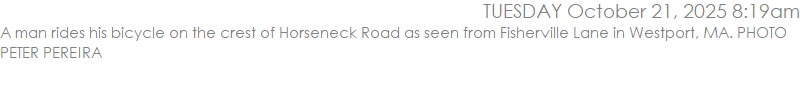 A man rides his bicycle on the crest of Horseneck Road as seen from Fisherville Lane in Westport, MA. PHOTO PETER PEREIRA