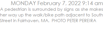 A pedestrian is surrounded by signs as she makes her way up the walk/bike path adjacent to South Street in Fairhaven, MA.  PHOTO PETER PEREIRA