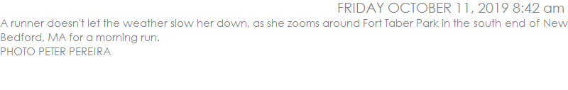 A runner doesn't let the weather slow her down, as she zooms around Fort Taber Park in the south end of New Bedford, MA for a morning run. 