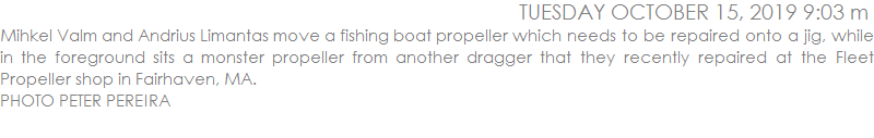 Mihkel Valm and Andrius Limantas move a fishing boat propeller which needs to be repaired onto a jig, while in the foreground sits a monster propeller from another dragger that they recently repaired at the Fleet Propeller shop in Fairhaven, MA.