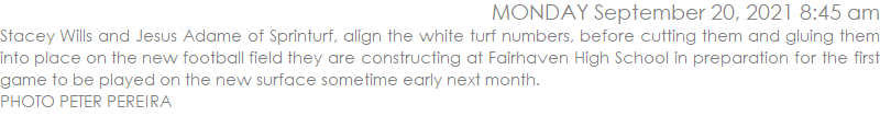 Stacey Wills and Jesus Adame of Sprinturf, align the white turf numbers, before cutting them and gluing them into place on the new football field they are constructing at Fairhaven High School in preparation for the first game to be played on the new surface sometime early next month.
