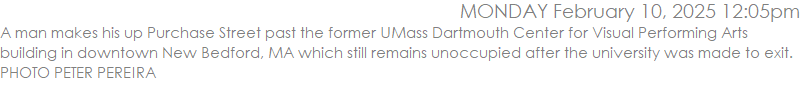 A man makes his up Purchase Street past the former UMass Dartmouth Center for Visual Performing Arts building in downtown New Bedford, MA which still remains unoccupied after the university was made to exit. PHOTO PETER PEREIRA