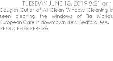 Douglas Cutler of All Clean Window Cleaning is seen cleaning the windows of Tia Maria's European Cafe in downtown New Bedford, MA.