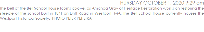 The bell of the Bell School House looms above, as Amanda Gray of Heritage Restoration works on restoring the steeple of the school built in 1841 on Drift Road in Westport, MA. The Bell School House currently houses the Westport Historical Society.  PHOTO PETER PEREIRA